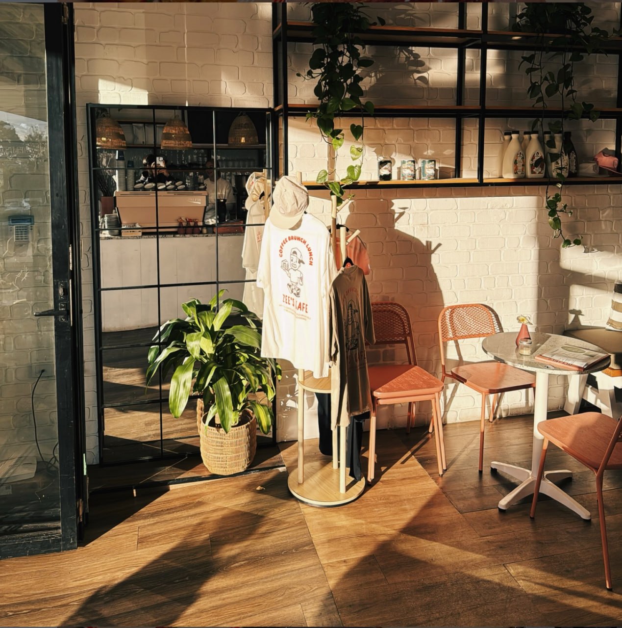 Merch and morning light by the front door